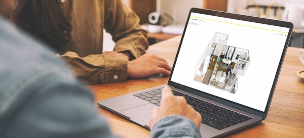 a man and a woman looking at a computer with a 3D HomeByMe project on the screen